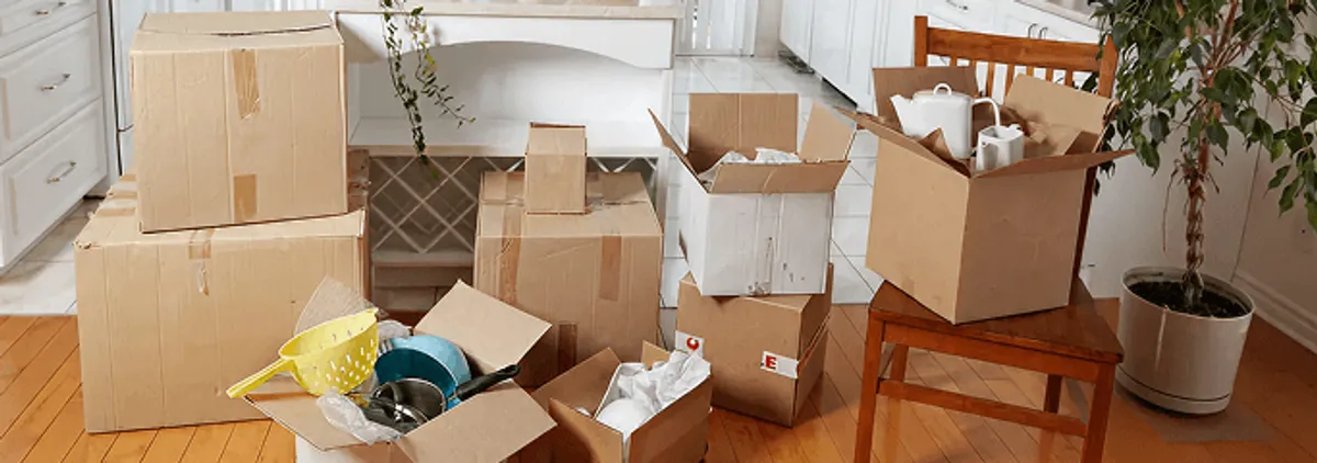 Packed moving boxes and household items in a kitchen before move-out or move-in cleaning, Chula Vista, CA.